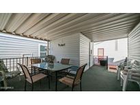 Covered patio with table and chairs, perfect for outdoor dining at 623 Hawks Eye Dr # 623, Apache Junction, AZ 85119