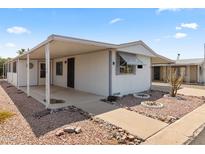 Mobile home with carport and desert landscaping at 3330 E Main St # 9, Mesa, AZ 85213