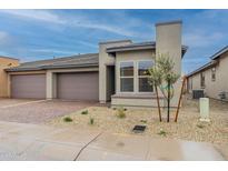 Modern home exterior, two-car garage, and landscaped front yard at 286 E Citrus Hollow Way, Queen Creek, AZ 85140