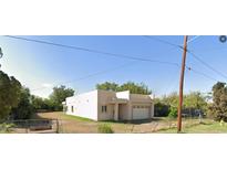Single-story house with attached garage and spacious yard at 909 W Tamarisk St, Phoenix, AZ 85041