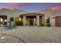 Elegant home entrance featuring a fountain and meticulously landscaped courtyard at 28448 N 95Th Pl, Scottsdale, AZ 85262