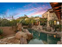 Luxury backyard oasis with a stunning pool and spa, surrounded by natural rock at 10040 E Happy Valley Rd # 676, Scottsdale, AZ 85255