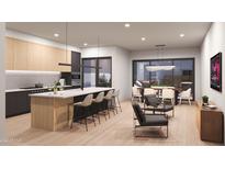 Modern kitchen features island, breakfast bar, and dining area at 6922 E 1St St, Scottsdale, AZ 85251