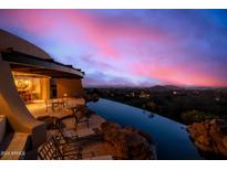 Infinity pool with mountain views at sunset at 11108 E Mariola Way, Scottsdale, AZ 85262