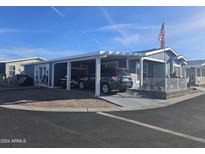 Inviting exterior of a manufactured home with carport and landscaping at 650 N Hawes Rd # 3202, Mesa, AZ 85207