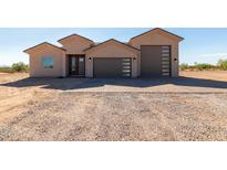 Modern desert home with two-car garage and gravel driveway at 31712 N 169Th Ave, Surprise, AZ 85387