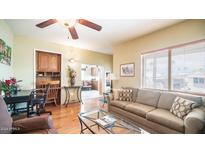 Bright living room with hardwood floors, comfortable seating, and a home office area at 412 Hawks Eye Dr, Apache Junction, AZ 85119