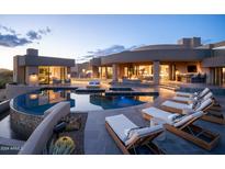 Luxury backyard oasis with a large pool and lounge chairs at 41851 N 112Th Pl, Scottsdale, AZ 85262
