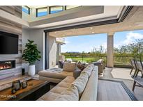 Living room with sectional sofa, fireplace and access to outdoor patio at 37200 N Cave Creek Rd # 2124, Scottsdale, AZ 85262