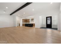 Open concept living area with hardwood floors and a kitchen island at 17448 W Carlisle Dr, Surprise, AZ 85388