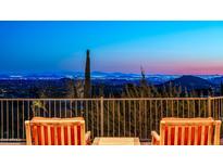 Panoramic city views from a balcony with chairs at 11070 E Rolling Rock Dr, Scottsdale, AZ 85262