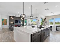 Modern kitchen with large island and high-end appliances at 17316 W Wildwood St, Surprise, AZ 85388