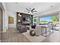 Spacious living room with modern fireplace and access to backyard at 17316 W Wildwood St, Surprise, AZ 85388