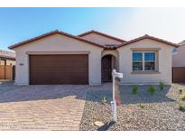 New single-story home with a brown garage door and a landscaped yard at 18741 E Elizar Dr, Gold Canyon, AZ 85118