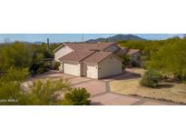 Two-car garage and a large driveway with desert landscaping at 39012 N 8Th St, Phoenix, AZ 85086