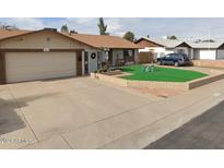 A ranch-style home with a large yard, double-car garage and mature landscaping at 15022 N 35Th Ave, Phoenix, AZ 85053