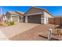 Modern home with a two-car garage and landscaped yard at 24041 N 171St Ln, Surprise, AZ 85387