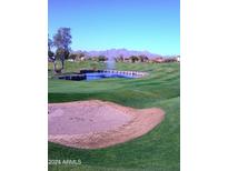 Stunning golf course view with a pond and mountain backdrop at 6547 E Sierra Morena St, Mesa, AZ 85215