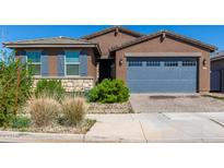 Two-story home with gray garage door and landscaping at 40762 W Williams Way, Maricopa, AZ 85138