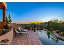 Inviting pool area with lounge chairs and scenic sunset view at 10284 E Filaree Ln, Scottsdale, AZ 85262