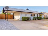 Remodeled single story home with a carport and well-manicured front yard at 2033 W Sunnyside Ave, Phoenix, AZ 85029