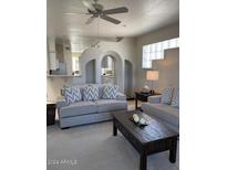Spacious living room with comfortable seating and a view of the kitchen at 11011 N Zephyr Dr # 210, Fountain Hills, AZ 85268