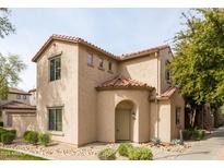 Tan two-story home with Spanish-style accents and landscaping at 3704 W Vivian Ct, Phoenix, AZ 85086