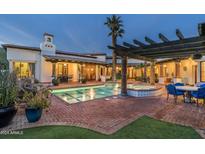Luxury backyard oasis with a sparkling pool, spa, and covered patio at 5842 E Redwing Rd, Paradise Valley, AZ 85253