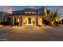Stunning home exterior at dusk with landscaped grounds at 10751 E Candlewood Dr, Scottsdale, AZ 85255
