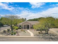 Single story house with landscaped yard and driveway at 6963 E Grandview St, Mesa, AZ 85207