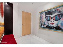 Modern entryway with large artwork and a red bench at 7157 E Rancho Vista Dr # 3006, Scottsdale, AZ 85251