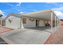 Mobile home with carport and landscaped front yard at 11596 W Sierra Dawn Blvd # 261, Surprise, AZ 85378