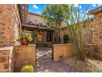 Ornate iron gate leads to the home's entrance at 28080 N 101St St # 116, Scottsdale, AZ 85262