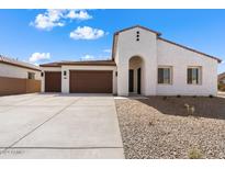 Modern stucco home with a three-car garage and desert landscaping at 37645 W Padilla St, Maricopa, AZ 85138