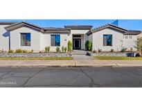 Modern single-story home with a clean, white facade at 11905 N 83Rd Pl, Scottsdale, AZ 85260