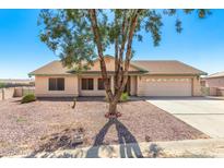 One-story home with desert landscaping and a two-car garage at 14360 S Cienega Ln, Arizona City, AZ 85123