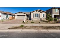Charming single-story home with a two-car garage and landscaped front yard at 21726 E Lords Way, Queen Creek, AZ 85142