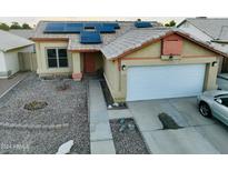 House front with solar panels, double garage, and basketball hoop at 11322 W Diana Ave, Peoria, AZ 85345
