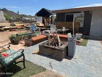 Backyard patio with fire pit and seating at 1535 E Christy Dr, Phoenix, AZ 85020