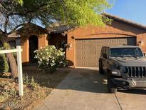 One-story home with two-car garage and landscaped yard at 46157 W Holly Dr, Maricopa, AZ 85139