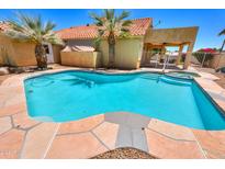 Inviting kidney-shaped pool with flagstone decking at 1247 E Marketplace Se Way, Phoenix, AZ 85048