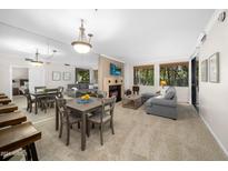 Bright living room with dining area and fireplace at 7700 E Gainey Ranch Rd # 103, Scottsdale, AZ 85258