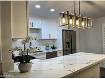 Modern kitchen with white cabinets and quartz countertops at 4950 N Miller Rd # 220, Scottsdale, AZ 85251