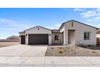 Two-car garage home with desert landscaping and a neutral color palette at 37535 W Padilla St, Maricopa, AZ 85138
