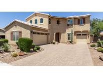 Two-story house with beige facade and landscaped yard at 20230 E Escalante Rd, Queen Creek, AZ 85142