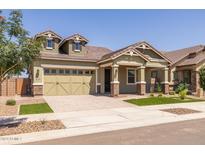 Two-story house with dormer windows, a green-painted garage, and a well-kept lawn at 19749 S 231 St. Way, Queen Creek, AZ 85142
