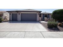 Two-car garage and front yard landscaping at 21853 N 261St Ave, Buckeye, AZ 85396