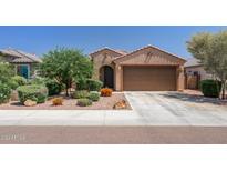 Attractive single-story home with a two-car garage and well-manicured landscaping at 20138 W Madison St, Buckeye, AZ 85396