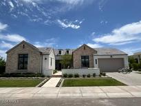Stunning two-story home with brick exterior and landscaped yard at 5755 S Joshua Tree Ln, Gilbert, AZ 85298