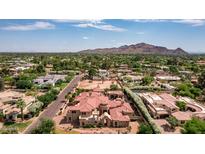 Impressive estate home with red tile roof, surrounded by lush landscaping at 6215 E Turquoise Ave, Paradise Valley, AZ 85253